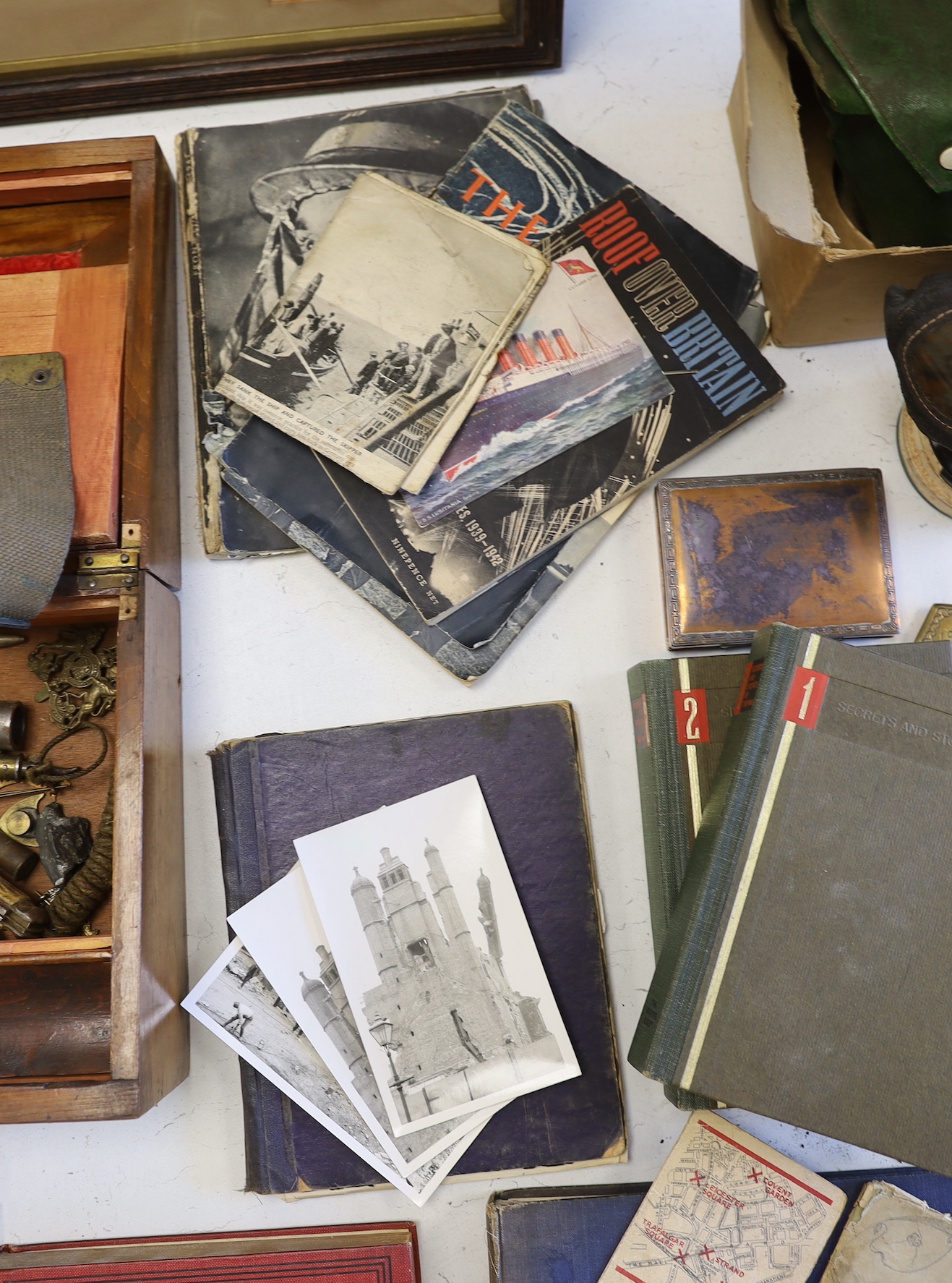 A quantity of war memorabilia including gas masks, postcards etc